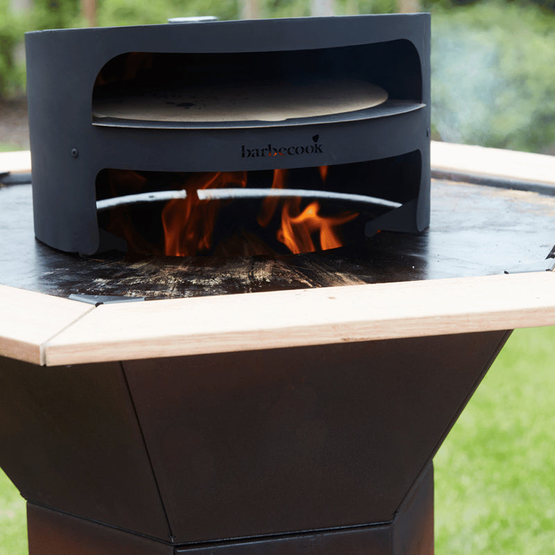 Barbecook Dynamic Pizza oven on flame with side table