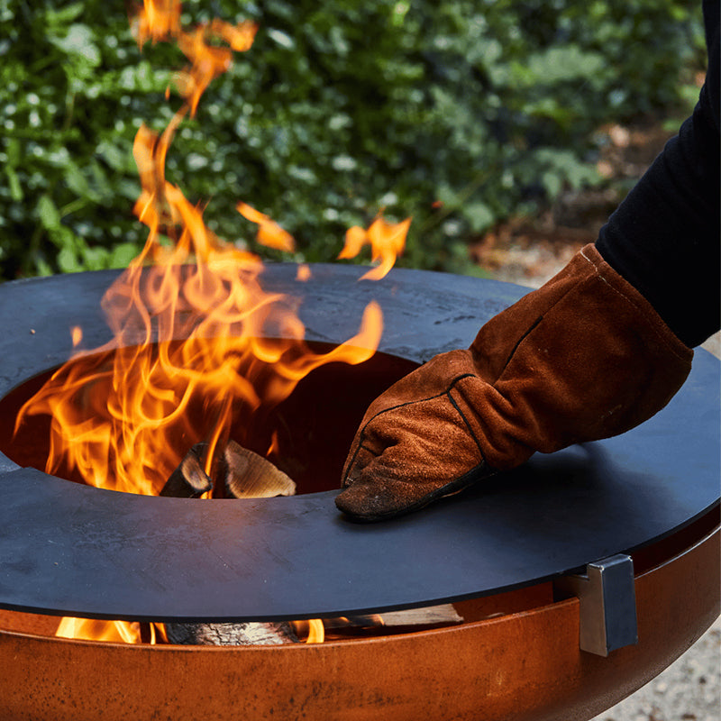 Barbecook Jack Firepit with gloved hand