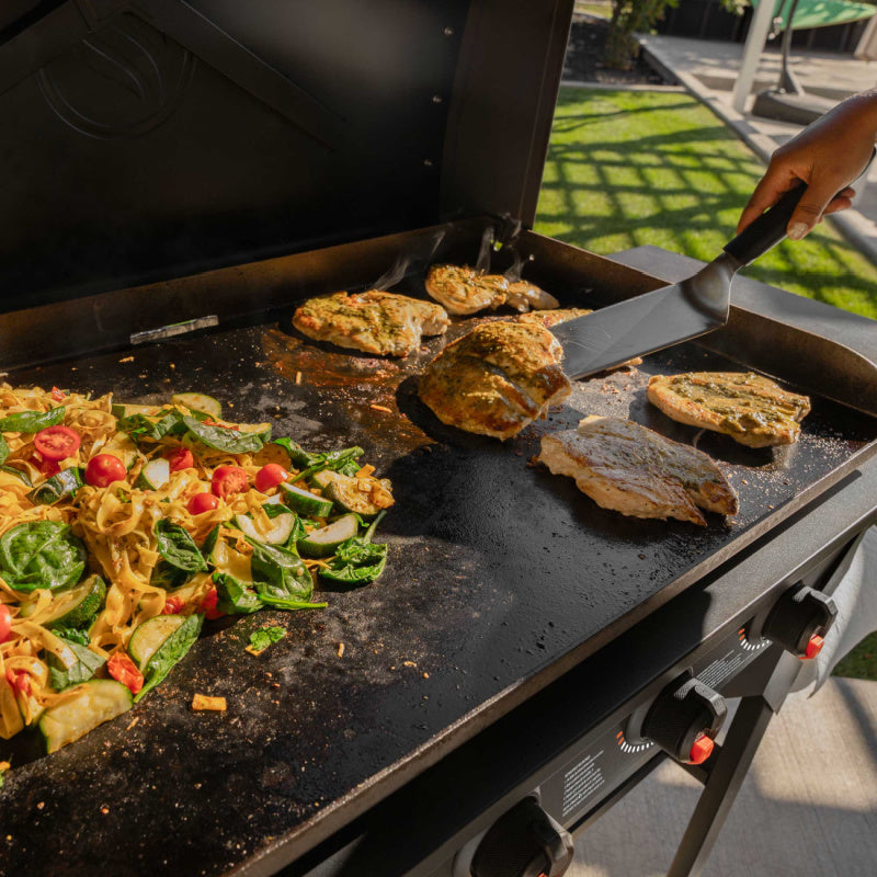 Blackstone 2310 36in Iron Forged Griddle with Hood Cooking chicken and pasta