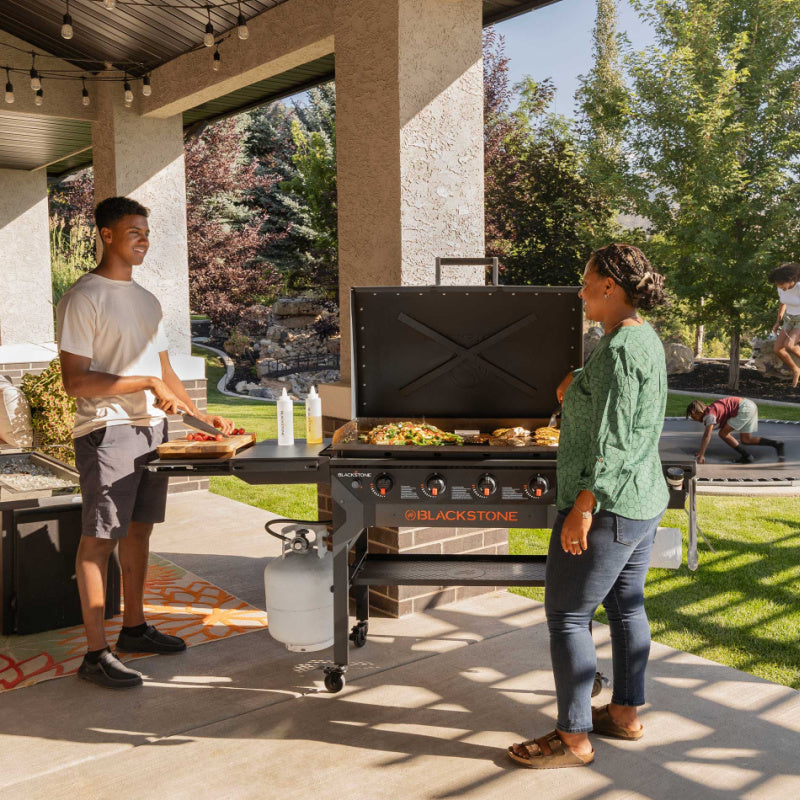 Blackstone 2310 36in Iron Forged Griddle with Hood Cooking and prepping outside