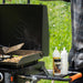 Blackstone 2350 22 inch On The Go Omnivore FlexFold Griddle with oils on the side table