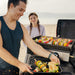 Blackstone 2140 22in Tabletop Griddle cooking at the beach