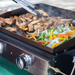 Blackstone 2140 22in Tabletop Griddle full cooking chicken and vegetables
