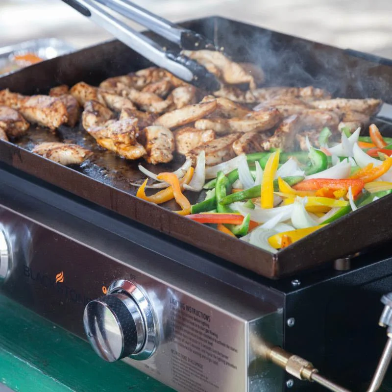 Blackstone 2140 22in Tabletop Griddle full cooking chicken and vegetables