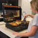 Blackstone 22inch E Series Electric Griddle woman cooking on bench