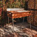 GrillSymbol Charcoal Grill Naked Chef XXL outside on tiles next to firewood racks