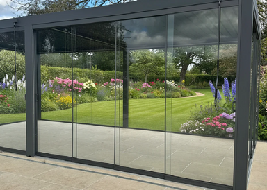 Suns Lifestyle Luxe glass sliding door in garden