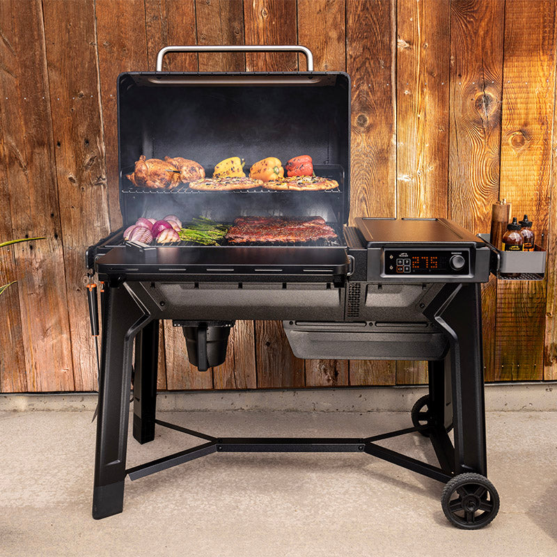 Traeger Woodridge open hood with grills full of food cooking