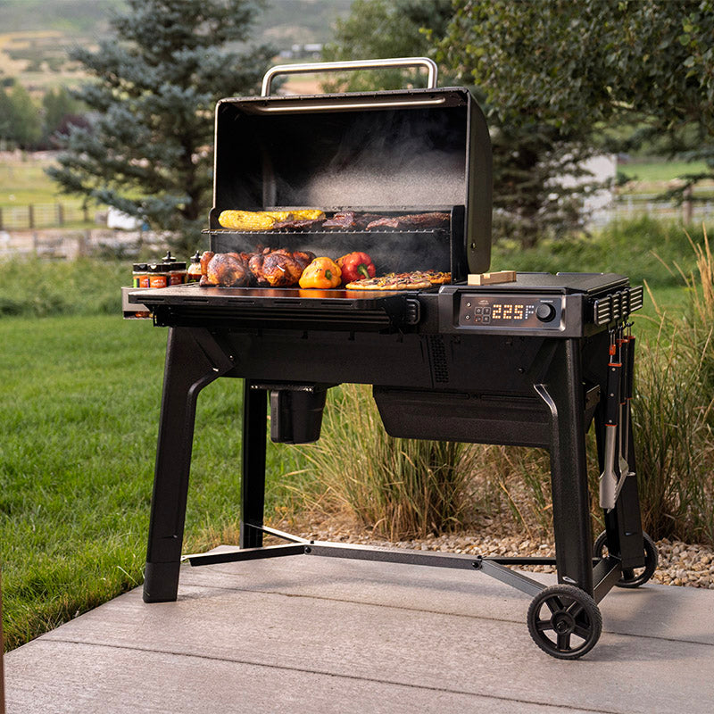 Traeger Woodridge outside grilling food on patio